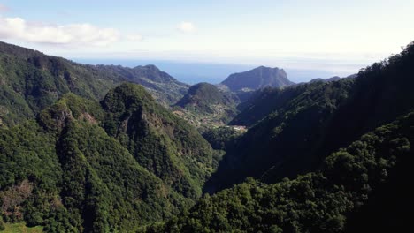 Aerial-reveal-of-green-mountain-valley-with-vegetation-ridge,-Madeira