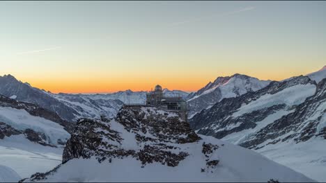 Epic-Wide-Aerial-of-the-Jungfraujoch-in-Switzerland-during-Sunrise-and-with-Beautiful-White-Snow