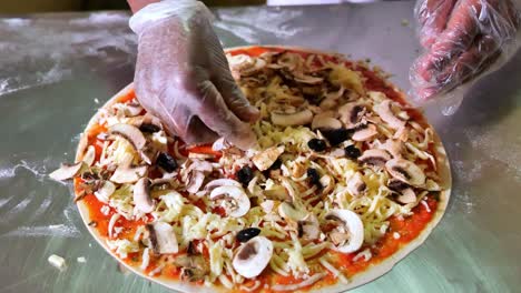 Adding-Mushroom-On-Top-Of-Tasty-Italian-Pizza