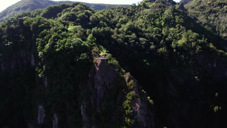 Aerial-of-tourist-on-a-viewpoint-platform-on-top-of-a-cliff,-Levada-dos-Balcoes