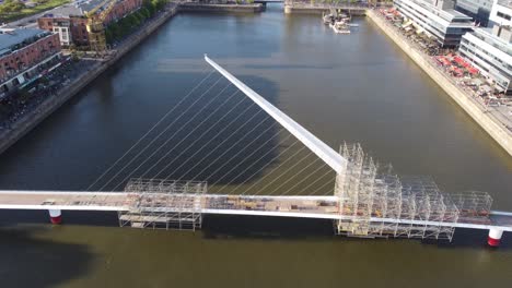 Aerial-flight-over-Woman's-Bridge-during-constriction-site-at-Puerto-Madero-Area-in-Buenos-Aires-City