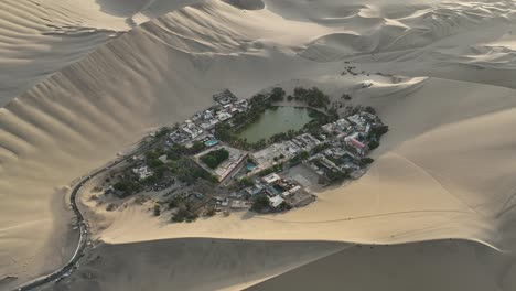 Orbit-Shot-Of-Isolated-Town-Surrounded-With-Sand-Dunes,-Ica,-huacachina,-peru