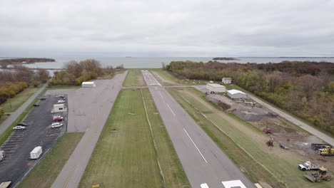 Small-plane-taking-off-from-runway-on-small-rural-airport-in-Put-in-Bay,-Ohio,-USA