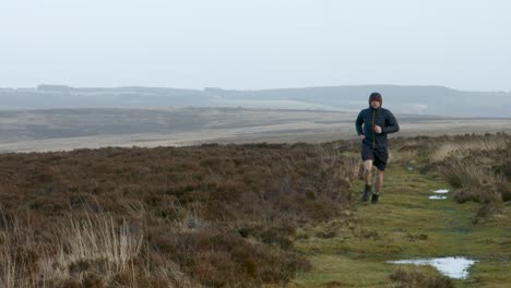 Male-Athlete-Runner-Training-Over-Moorland-Countryside-Along-Path-UK-4K