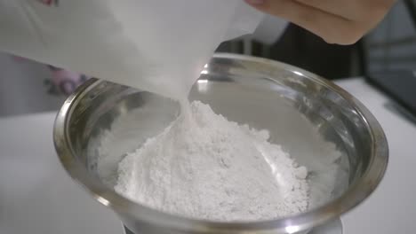 Pour-flour-into-bowl,-preparation-ingredients