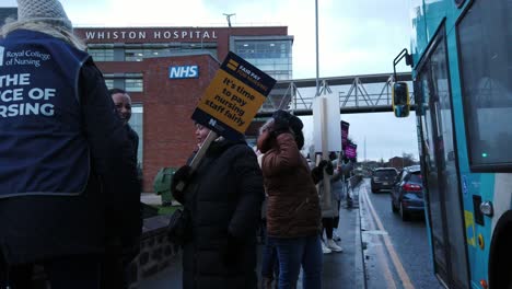 NHS-nurses-strikes,-waving-banners-and-flags-demanding-fair-pay-and-better-patient-care