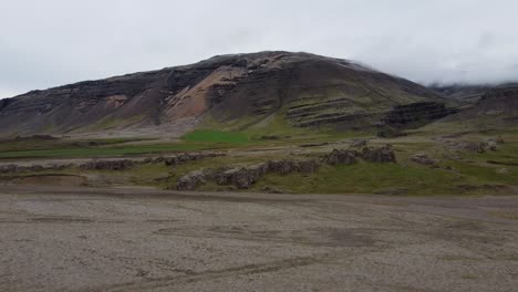 Volcanic-ash-and-moss-covered-mountain-landscape-on-Iceland-in-aerial-dolly-in