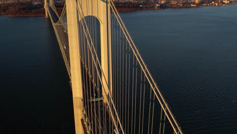 Aerial-view-of-cars-on-the-Verrazzano-Narrows-bridge,-revealing-the-Staten-island,-spring-in-sunny-New-York,-USA---circling,-tilt,-drone-shot