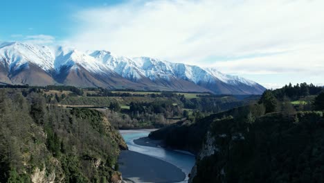 Aerial-reverse-above-beautiful-Rakaia-River-Gorge---early-morning,-mid-winter,-fresh-snow-on-Mount-Hutt