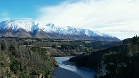 Aerial-ascent-above-beautiful-Rakaia-River-Gorge---early-morning,-mid-winter,-fresh-snow-on-Mount-Hutt
