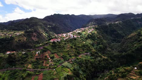 Aerial-panorama-of-a-village-on-top-of-green-mountain-hill-valley,-Madeira