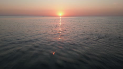 Beautiful-Sunrise-over-ocean,-fast-and-low-aerial-shot