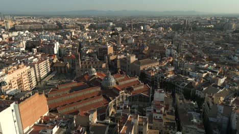 Orbiting-Aerial-shot-of-Valencia-central-market-and-old-town,-Spain