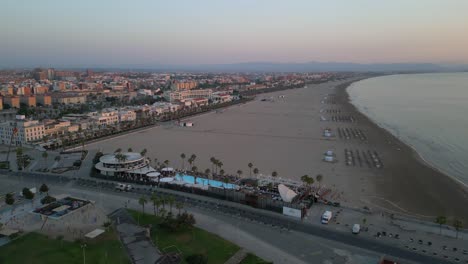 Early-morning-wide-aerial-shot-of-Valencia-beach,-Spain