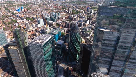 Close-up-aerial-view-of-Bishopsgate,-Nat-west-Tower-and-the-Gherkin-towers,-City-of-London,-UK