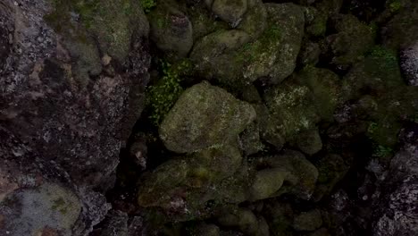 Mossy-rocks-in-aerial-downwards-ascending-view-in-Iceland-landscape