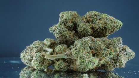Grayish-Green-Dried-Marijuana-Buds---Close-Up-concept-Shot,-pile-of-dried-marijuana-plants,-orange-trichomes-strains,-on-a-reflecting-rotating-stand,-studio-lights,-slow-motion,-4K-video-2