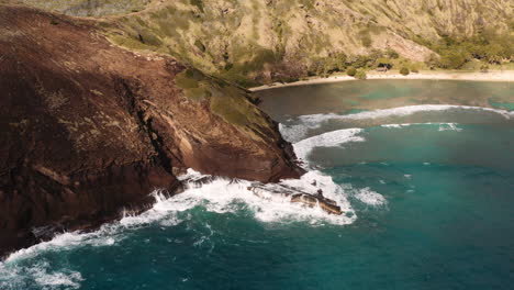Aerial-drone-shot-of-waves-crashing-against-rocky-coastline