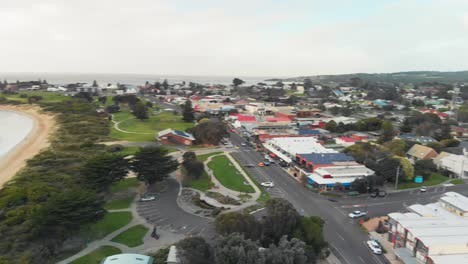 Drone-is-making-rotation-areal-video-shoot-over-residential-area-of-Apollo-Bay-Beach,-VIC,-Australia