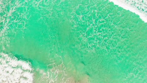 Orbit-Shot-Of-Cool-Waves-Crashing-On-Sandy-Beach,-Stunning-Turquoise-Water