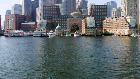 Low-drone-shot-approaching-Boston-skyline-from-Boston-harbor