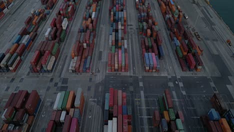 Aerial-view-of-cargo-containers-stack-at-dusk,-evening-4K