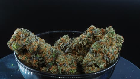 Purple-Green-Dried-Marijuana-Buds-Close-Up-concept-Shot,-pile-of-dried-marijuana-plants,-orange-trichomes-strains,-small-black-shiny-bawl,-on-a-rotating-stand,-studio-lights,-slow-motion,-4K,-smoke