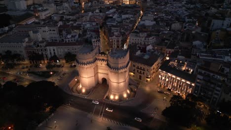 Night-Aerial-view-of-landmark-Torres-of-Serrano-and-Historic-old-City-Valencia,-Spain