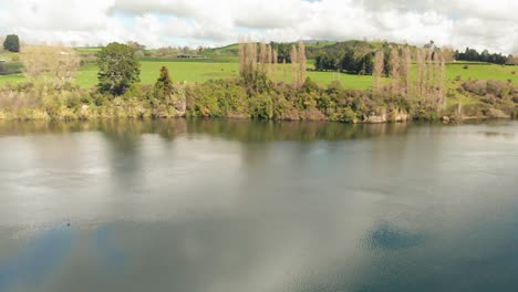 A-river-in-a-New-Zealand-countryside,-areal-rotating-video-sequence-during-nice-weather-day
