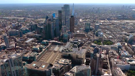 Aerial-view-of-Liverpool-Street-Station,-City-of-London-towers-and-the-Shard