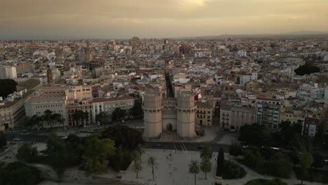 Sunset-Aerial-shot-of-historical-Serranos-Towers,-landmark-in-Spain,-Valencia