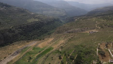 Aerial-View-of-Qadisha-Valley,-Lebanon,-Village,-Canyon-and-Green-Landscape-on-Sunny-Summer-Day-60fps