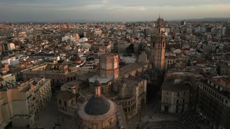 Aerial-view-of-Valencia,-Spain-panning-around-the-Miguelet-Bell-Tower-and-Cathedral-during-sunset