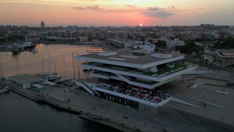 Aerial-view-of-Emblematic-La-Marítima-de-Veles-e-Vents-restaurant-in-Valencia-during-sunset,-Spain