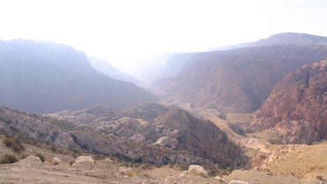 Panoramic-landscape-view-of-Wadi-Dana-natural-canyon-valley-and-Dana-Biosphere-Reserve,-vast,-rugged-mountainous-terrain-in-Jordan,-Middle-East