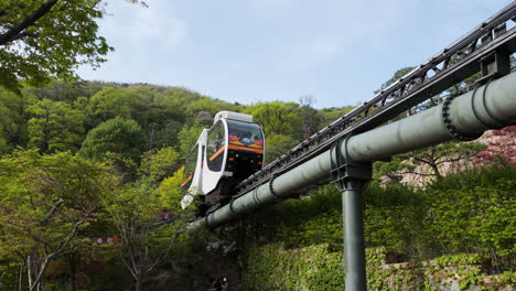 Monorail-Train-with-Travelers-Moving-on-Railroad-Track-Through-Hwadam-Botanic-Garden-or-Hwadamsup-in-Spring