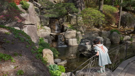 Schönes-Kleines-Mädchen,-Das-Süßwasser-Und-Die-Landschaft-Der-Wasserfälle-Im-Botanischen-Garten-Hwadam-In-Gwangju,-Südkorea,-Bewundert