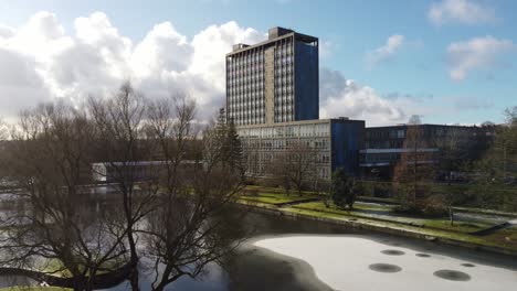 Pilkingtons-glass-head-quarters-blue-high-rise-business-office-park-tranquil-snowy-grounds-aerial-view