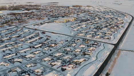 Aerial-panning-shot-of-white-snowy-Selfoss-City-during-winter-day-in-Iceland