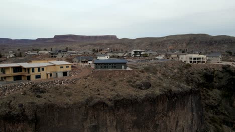 Houses-on-the-edge-of-a-cliff-then-ascending-to-reveal-the-southern-Utah-town-of-La-Verkin