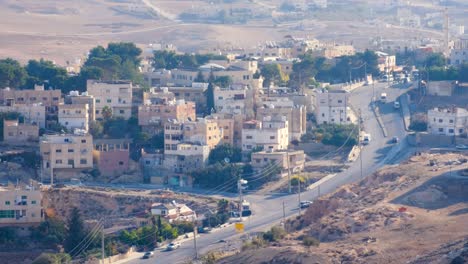 Multi-story-houses,-apartments-and-traffic-in-the-Arabian-city-of-Al-Karak-from-Kerak-Castle-in-Jordan,-Middle-East