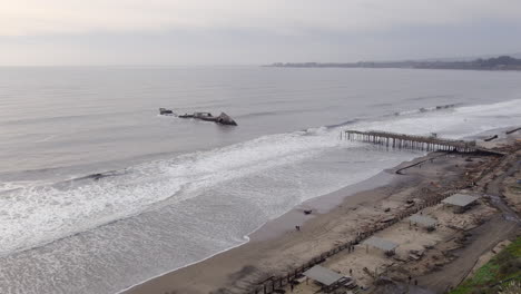 Seacliff-pier-tourist-destination-destroyed-in-a-storm-in-California-in-January-2023-aerial-orbiting-view