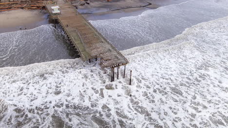 Aerial,-beach-pier-in-California-destroyed-by-a-storm-caused-by-climate-change
