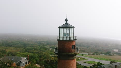 Aerial-drone-pull-back-from-Gay-Head-Lighthouse-on-Martha's-Vineyard-into-foggy-ocean