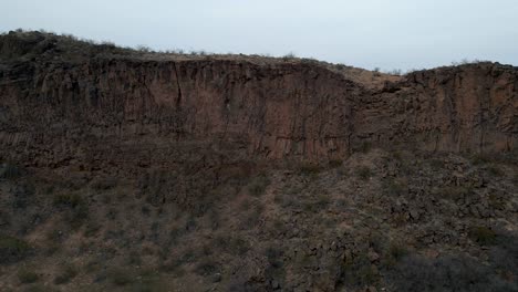 A-steep-cliff-overlooking-a-canyon-formed-by-erosion---static