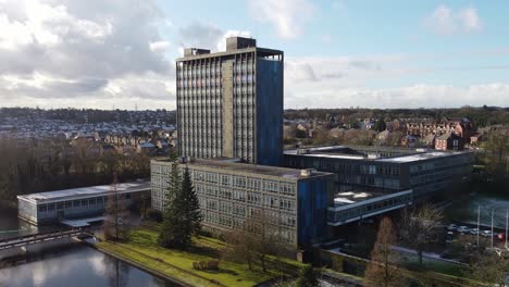 Pilkingtons-glass-head-quarters-blue-high-rise-business-office-park-aerial-rising-tilt-down-view