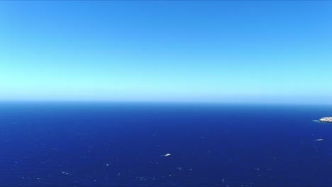 Aerial-4K-Blue-Sea-and-Sky-Top-View-Over-Akrotiri-Santorini-Greece-Horizon-Push-In
