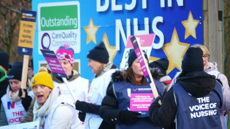 Merseyside-NHS-nurses-strike-for-fair-pay,-waving-banners-and-flags-outside-UK-hospital