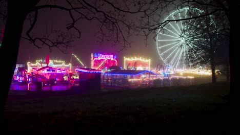 Wide-static-shot-of-a-bright,-colourful-fairground