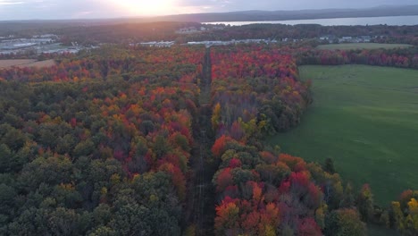 A-city-from-a-far-during-the-fall-months,-sunset--drone-video